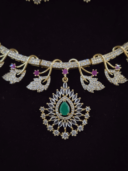 Zircon studded leaf design set with tear drop shaped green stone center hanging tukdi