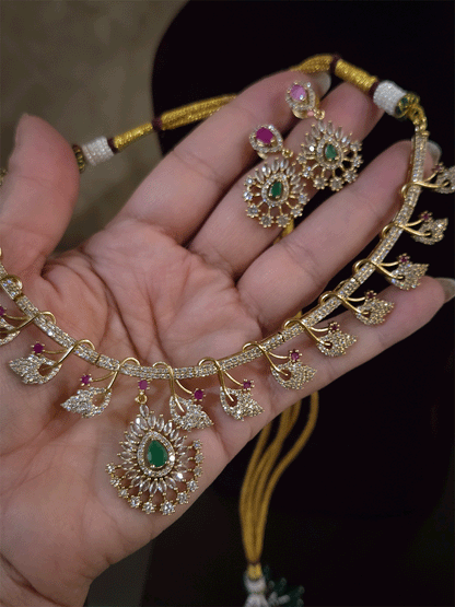 Zircon studded leaf design set with tear drop shaped green stone center hanging tukdi