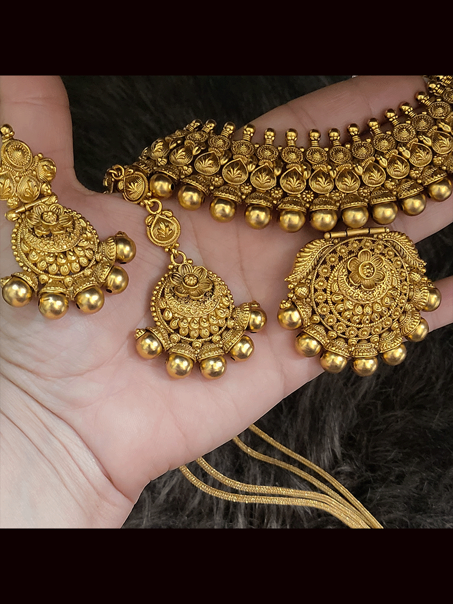 Bold gold bead design on classy self design broad necklace set with maangtika