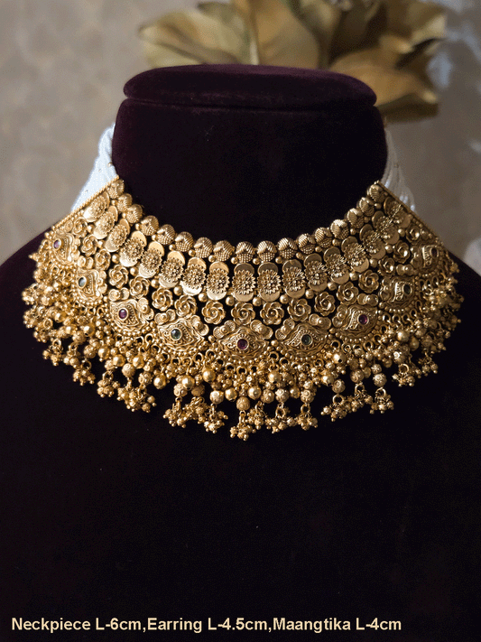 Intricate flower design ruby and green stones studded set with side cheed strings