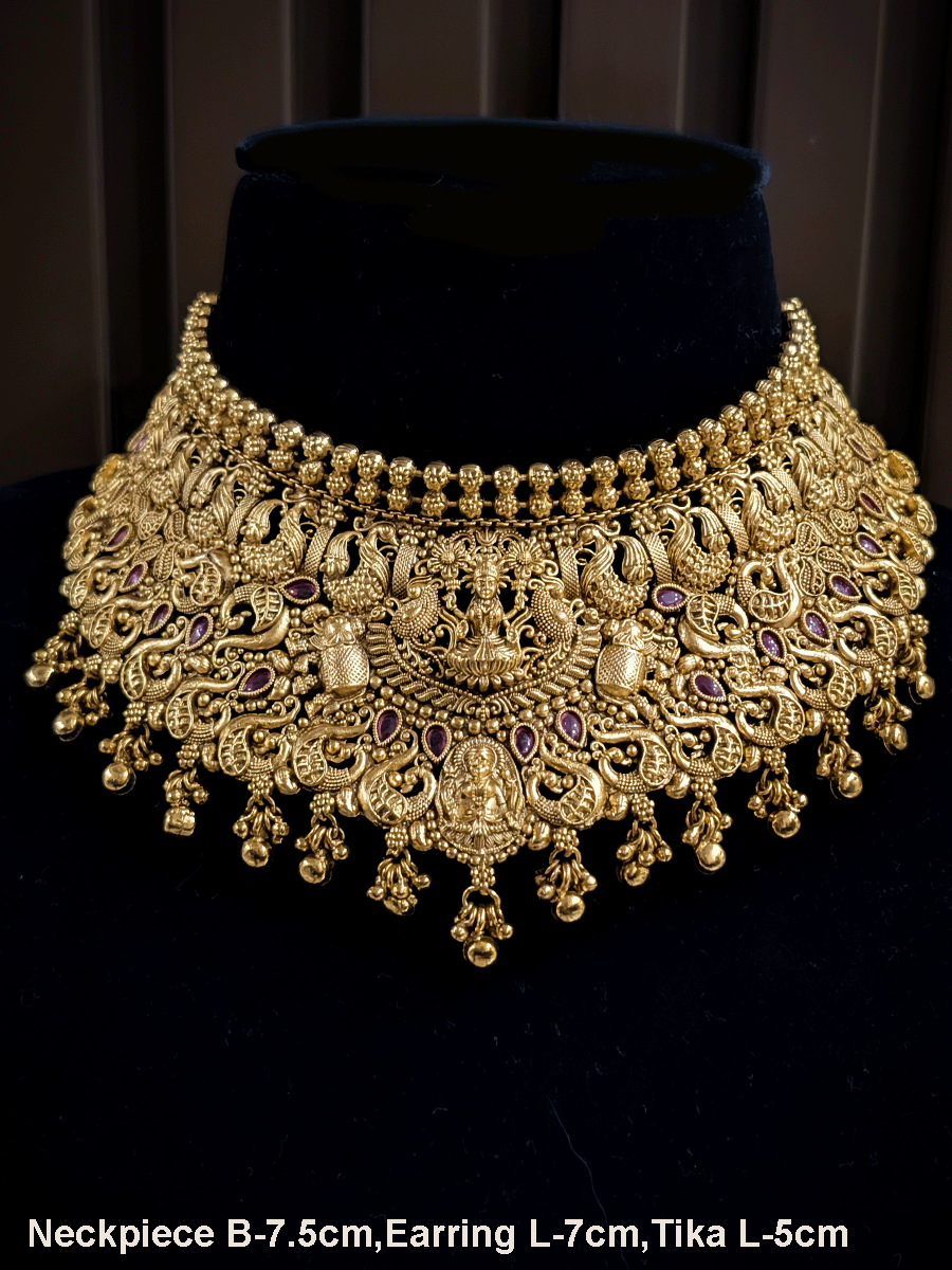 Classy laxmiji motif in center broad choker set with ruby stones and peacock design