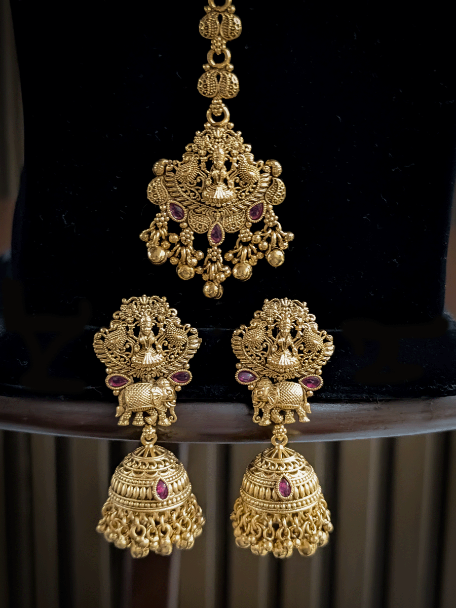 Classy laxmiji motif in center broad choker set with ruby stones and peacock design