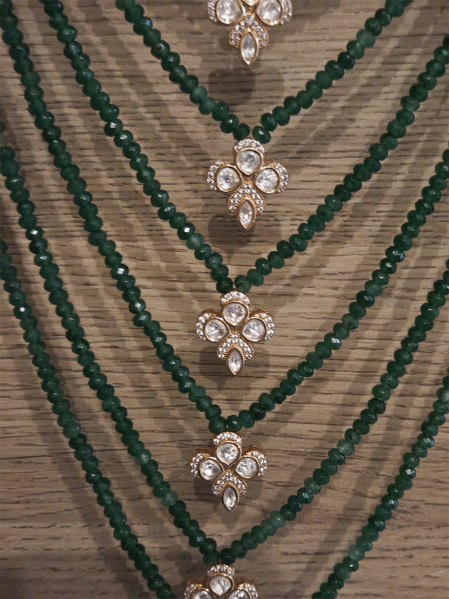 Seven layer onyx beads with half flower moissanite tukdies in center 17 inch long necklace