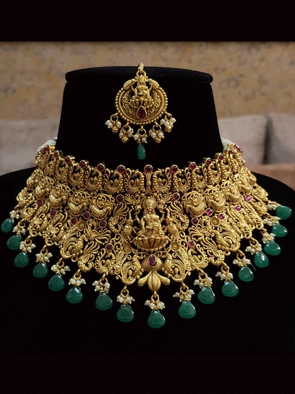 Broad green and ruby drops laxmiji choker set with intricate peacock motifs