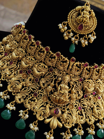 Broad green and ruby drops laxmiji choker set with intricate peacock motifs