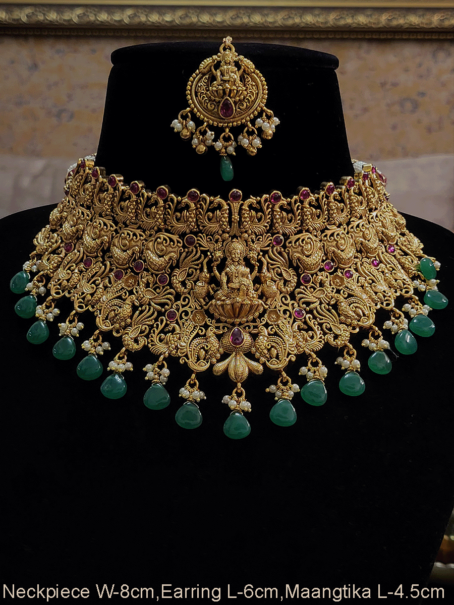 Broad green and ruby drops laxmiji choker set with intricate peacock motifs
