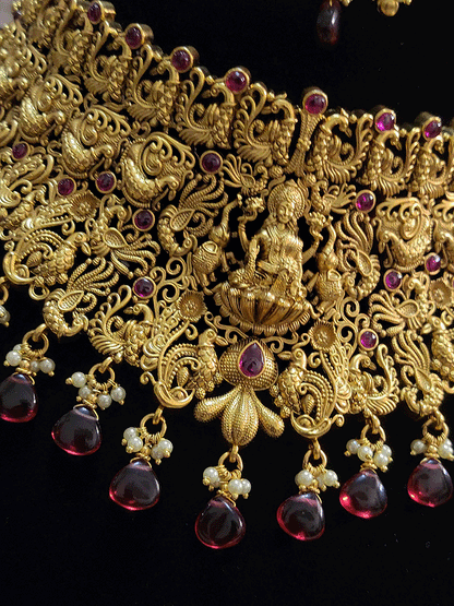 Broad green and ruby drops laxmiji choker set with intricate peacock motifs