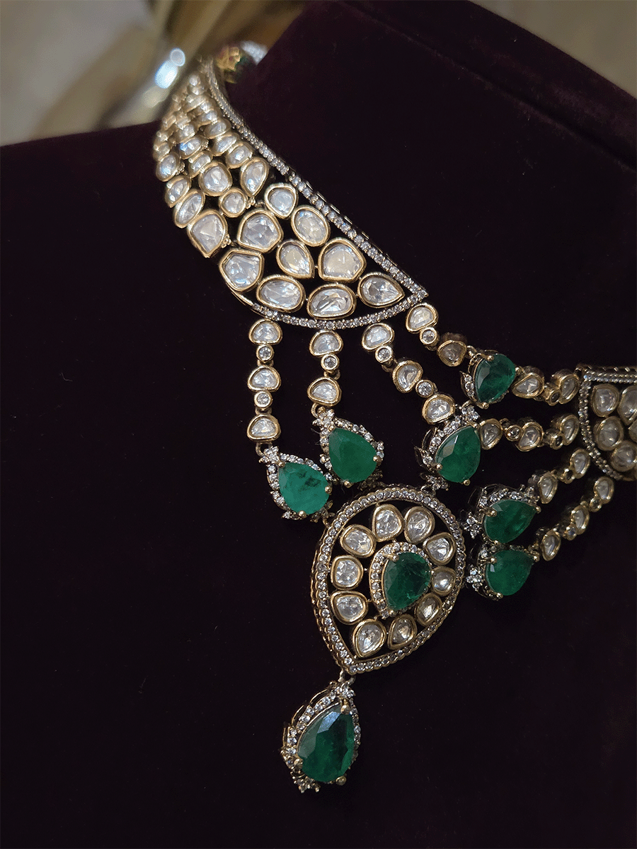 Moissanite set with connecting moissanite tukdies with green tear drop stones set