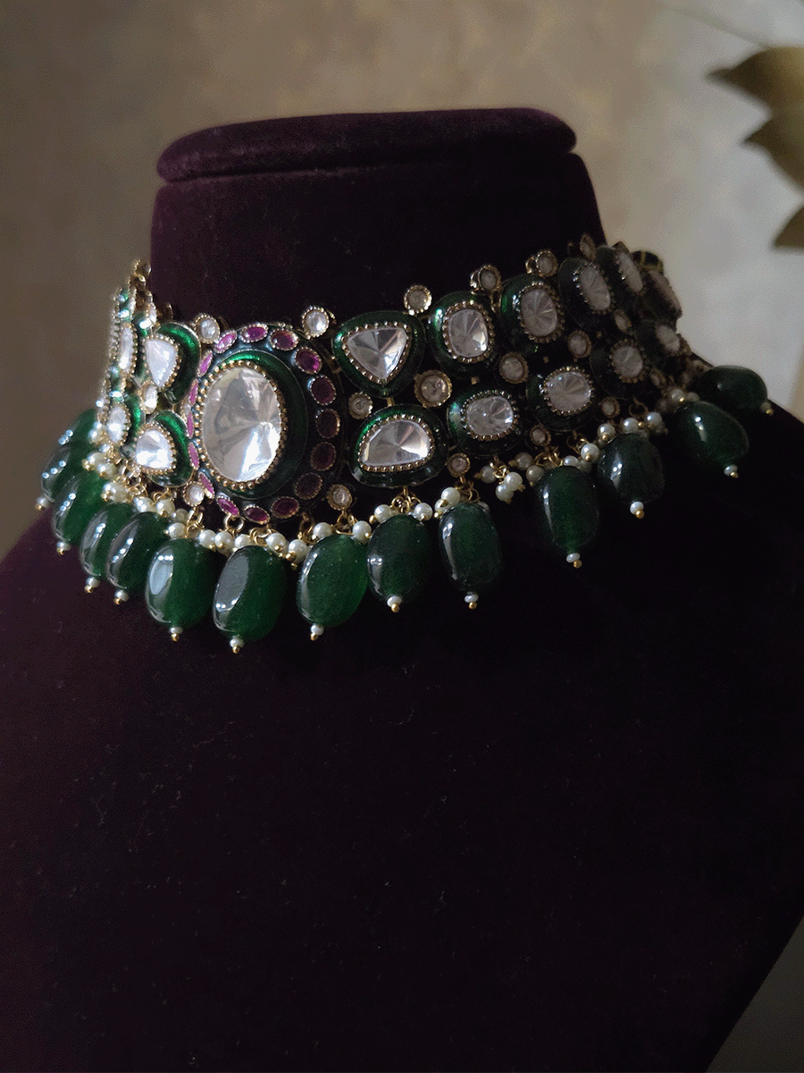 Bold oval uncut polki in center of green enamel choker set with green hanging beads