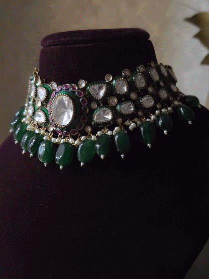 Bold oval uncut polki in center of green enamel choker set with green hanging beads