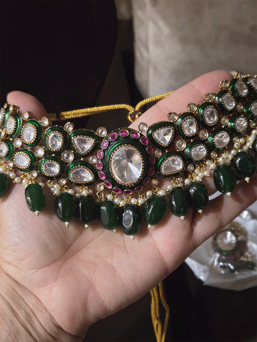 Bold oval uncut polki in center of green enamel choker set with green hanging beads