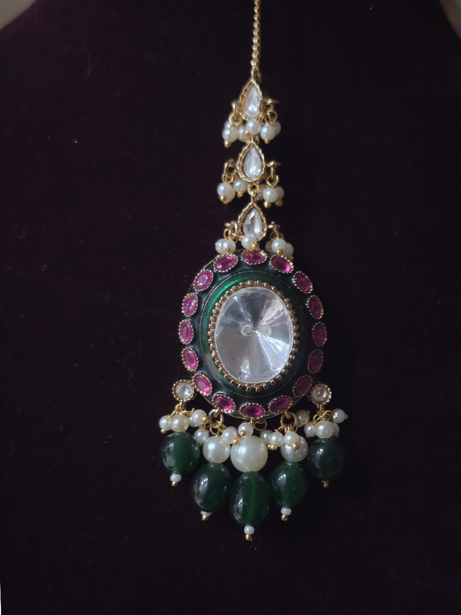 Bold oval uncut polki in center of green enamel choker set with green hanging beads