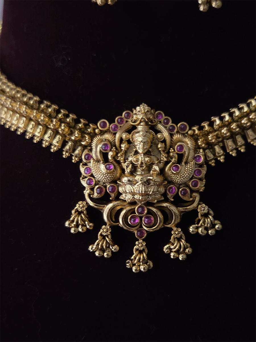 Ruby stones studded laxmiji motif set with side classy design chain