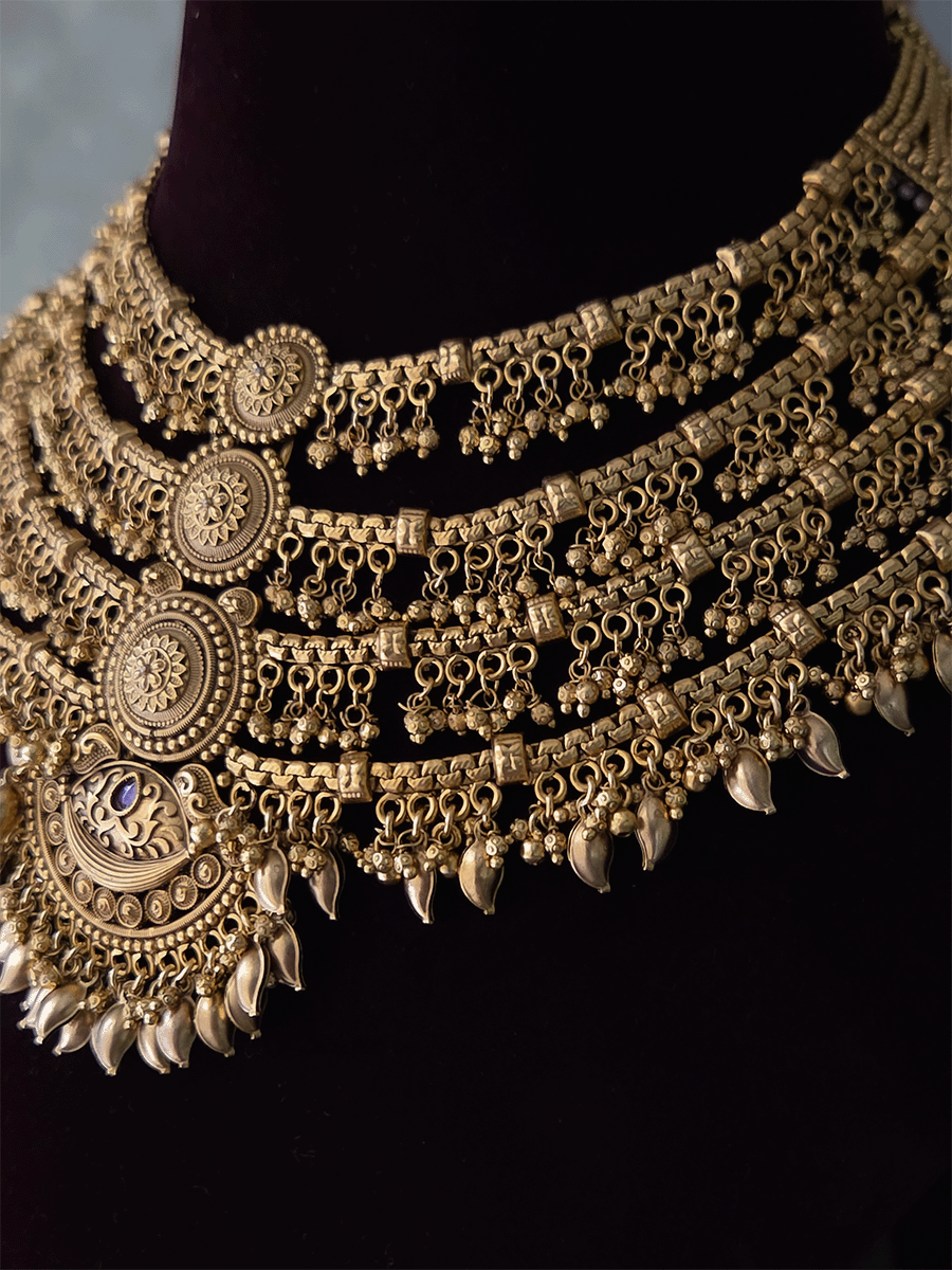 Four layer ghunghru hangings with center circular and half moon design set with leaf hangings