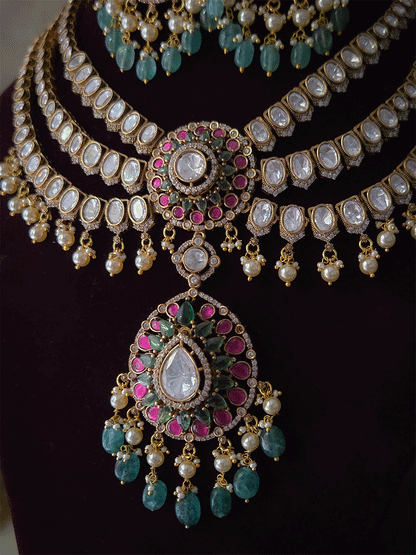 Triple layer moissanite strings set with ruby green circular tukdi in center and aqua drops leaf shaped hanging pendant