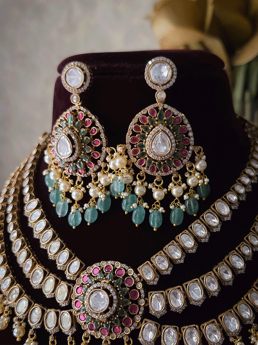 Triple layer moissanite strings set with ruby green circular tukdi in center and aqua drops leaf shaped hanging pendant