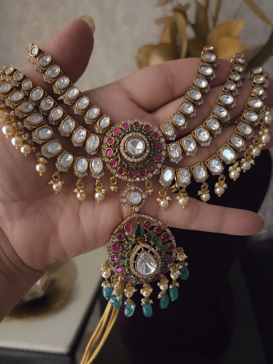 Triple layer moissanite strings set with ruby green circular tukdi in center and aqua drops leaf shaped hanging pendant