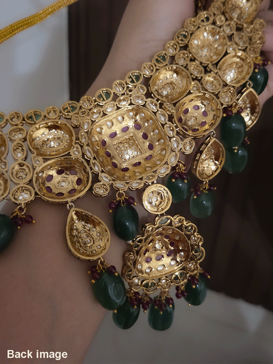 Green and ruby stones studded uncut polki broad set with big leaf shaped tukdi in center and four tear drop tukdies on sides