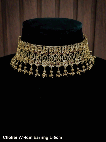 Intricate leaf and flower polki ruby and green stones choker set