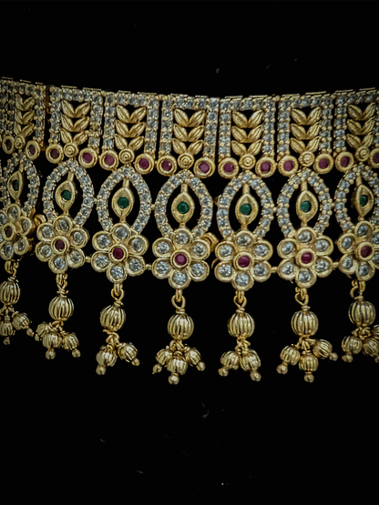 Intricate leaf and flower polki ruby and green stones choker set