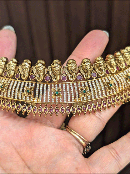 Ganpatiji motif's on top of AD studded choker with ruby and green stones flower