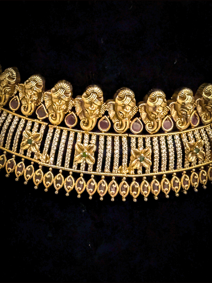 Ganpatiji motif's on top of AD studded choker with ruby and green stones flower
