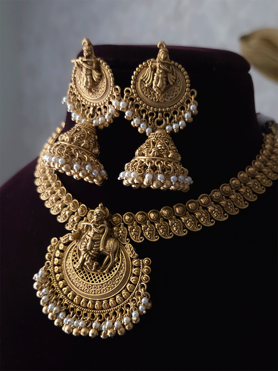 Krishnaji with cow motif on mesh design center necklace set with paisley design side chain