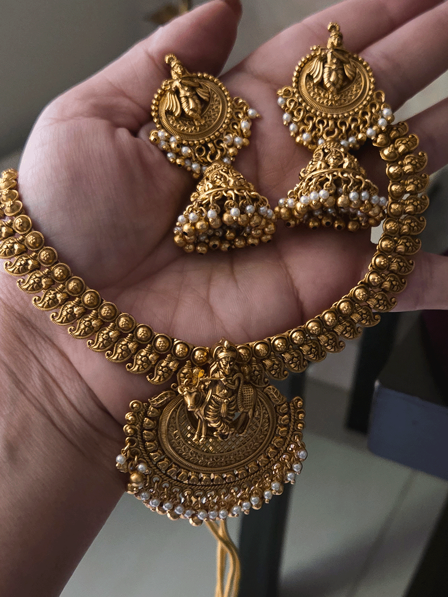 Krishnaji with cow motif on mesh design center necklace set with paisley design side chain