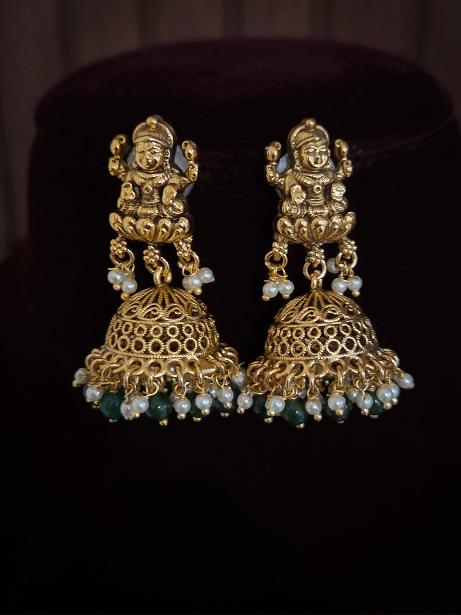 Laxmiji center with side peacock and green bead drops pendant in four green bead strings