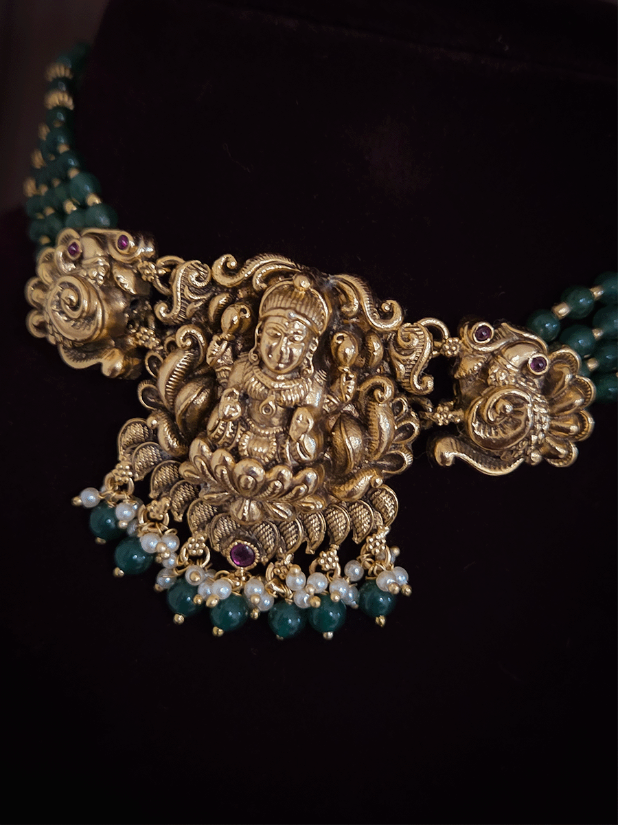 Laxmiji center with side peacock and green bead drops pendant in four green bead strings