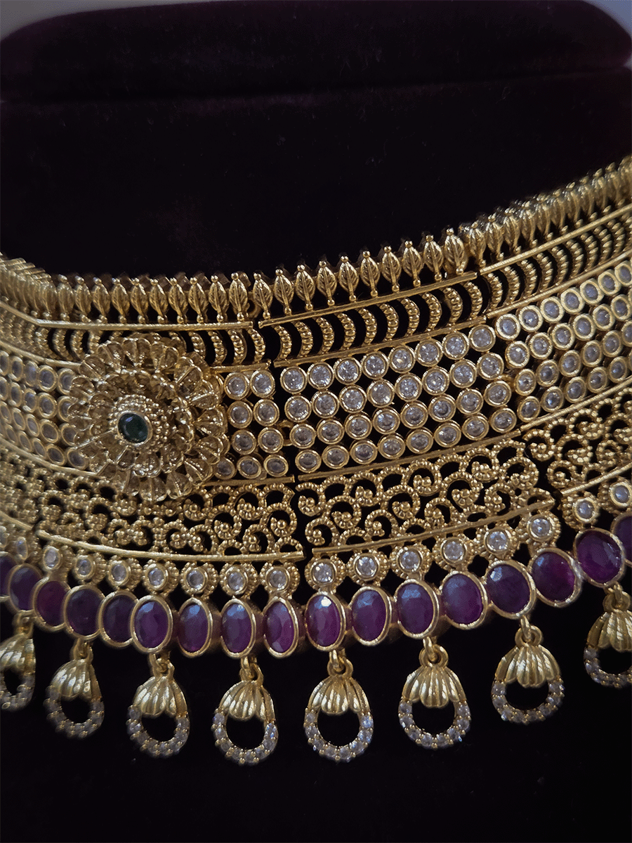 5cm broad flower center polki studded choker with oval ruby stones line and zircon loop hangings