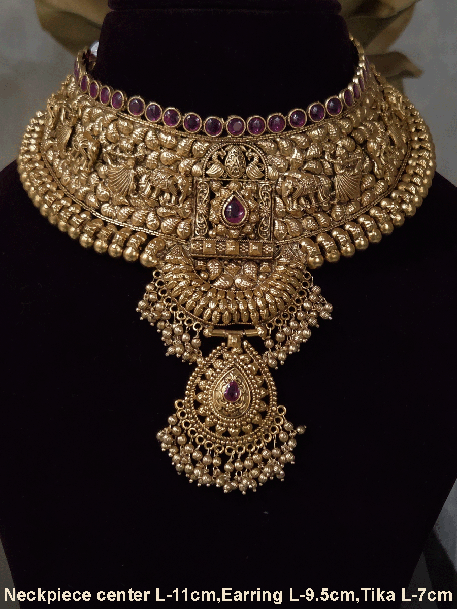Ruby stone top line of 11cm broad choker set with nrityangna's and elephants and leaf shaped hanging tukdi in center