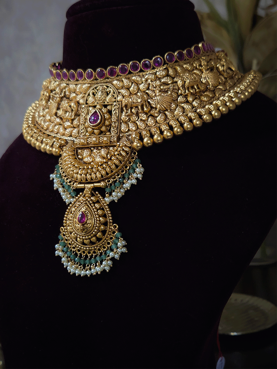 Ruby stone top line of 11cm broad choker set with nrityangna's and elephants and leaf shaped hanging tukdi in center