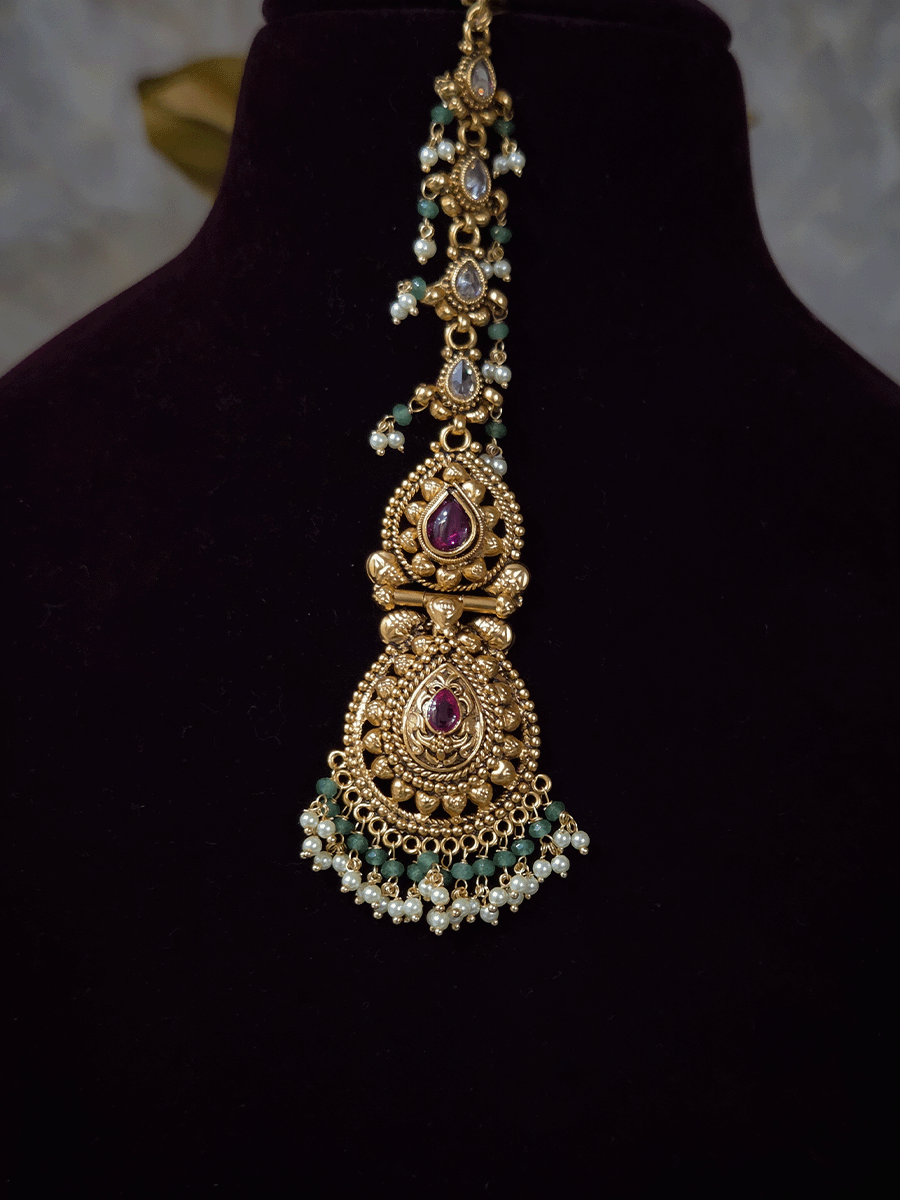 Ruby stone top line of 11cm broad choker set with nrityangna's and elephants and leaf shaped hanging tukdi in center