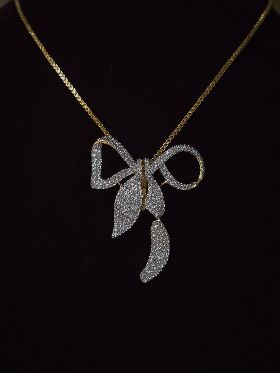 Bow with leaf zircon studded pendant in 7 inch long chain
