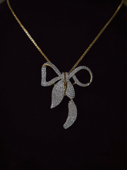 Bow with leaf zircon studded pendant in 7 inch long chain