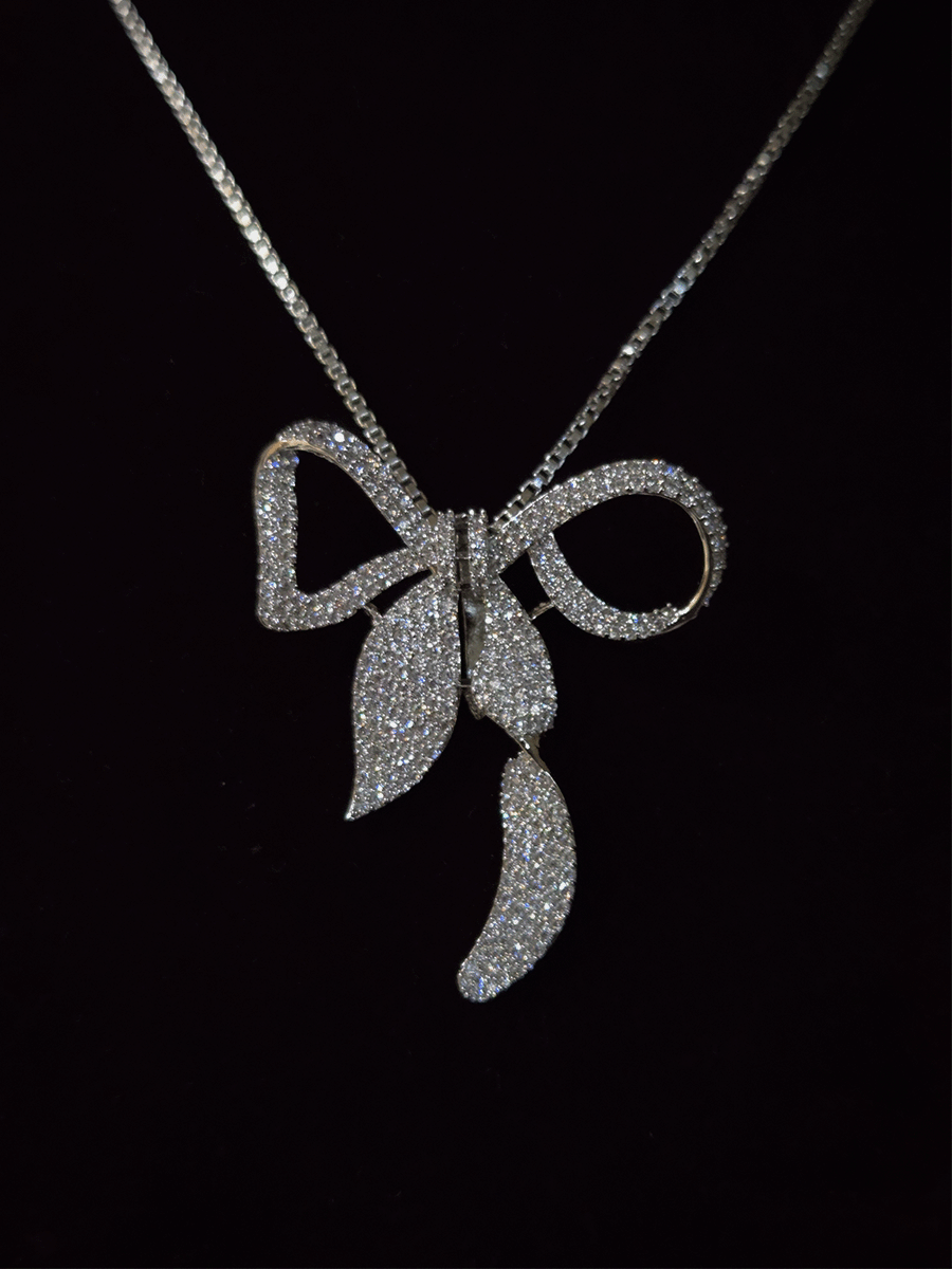 Bow with leaf zircon studded pendant in 7 inch long chain