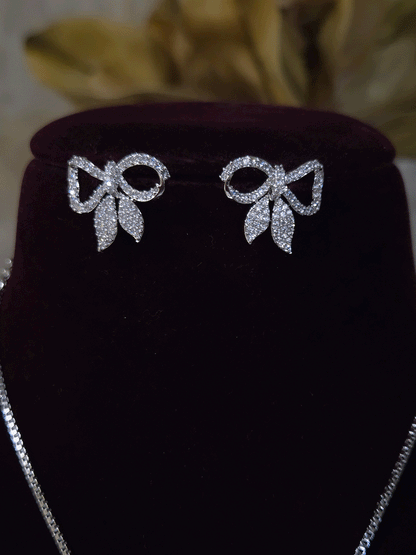 Bow with leaf zircon studded pendant in 7 inch long chain