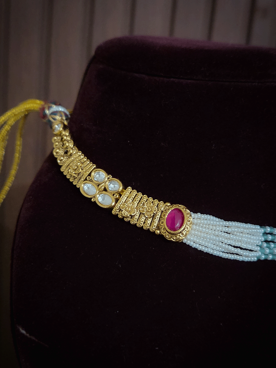 Oval ruby stone kundan flower center side cheed strings set