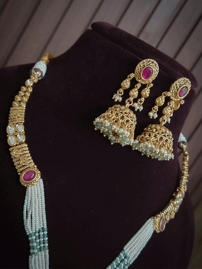 Oval ruby stone kundan flower center side cheed strings set
