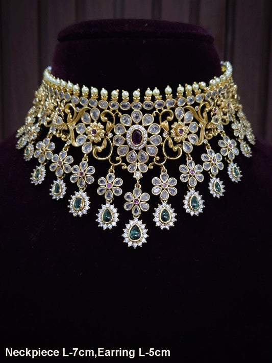 Polki,ruby and green stones studded flower and leaf tukdi tassel drops choker set