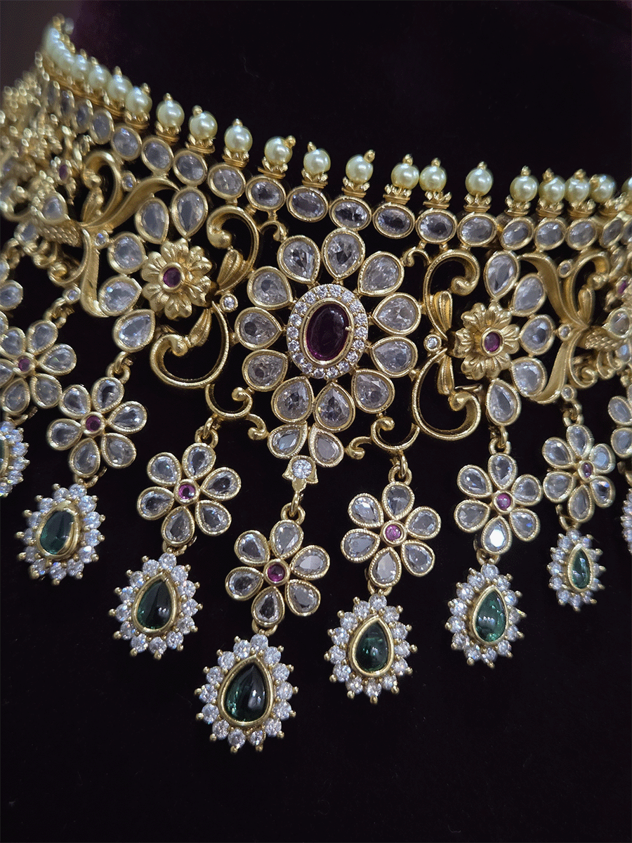 Polki,ruby and green stones studded flower and leaf tukdi tassel drops choker set