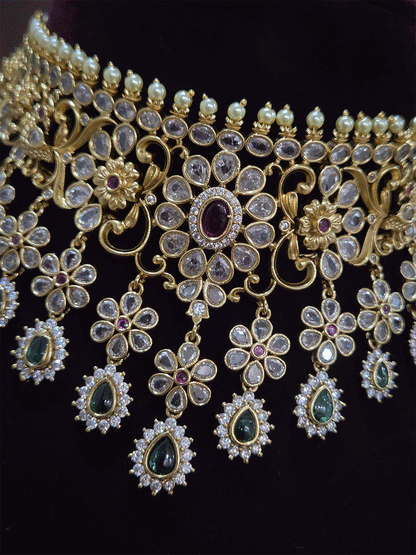 Polki,ruby and green stones studded flower and leaf tukdi tassel drops choker set