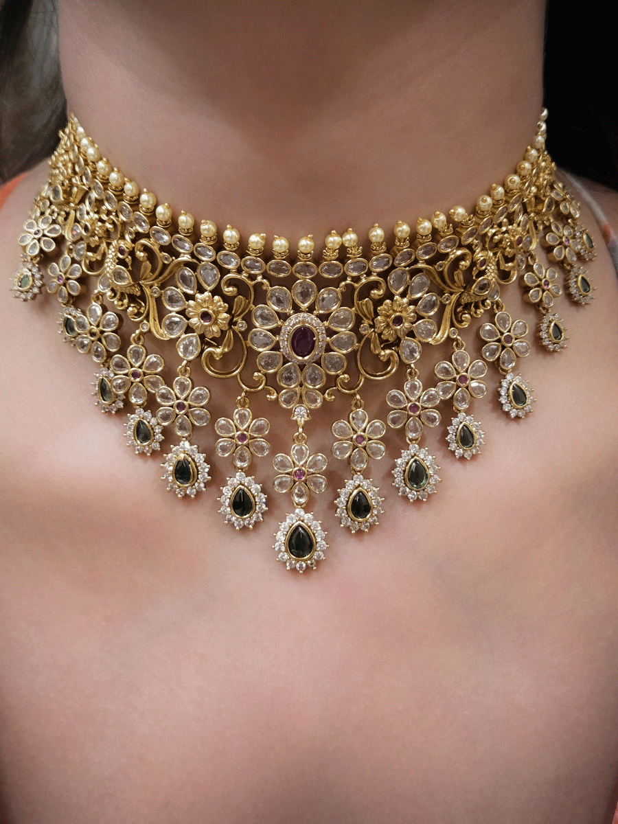 Polki,ruby and green stones studded flower and leaf tukdi tassel drops choker set