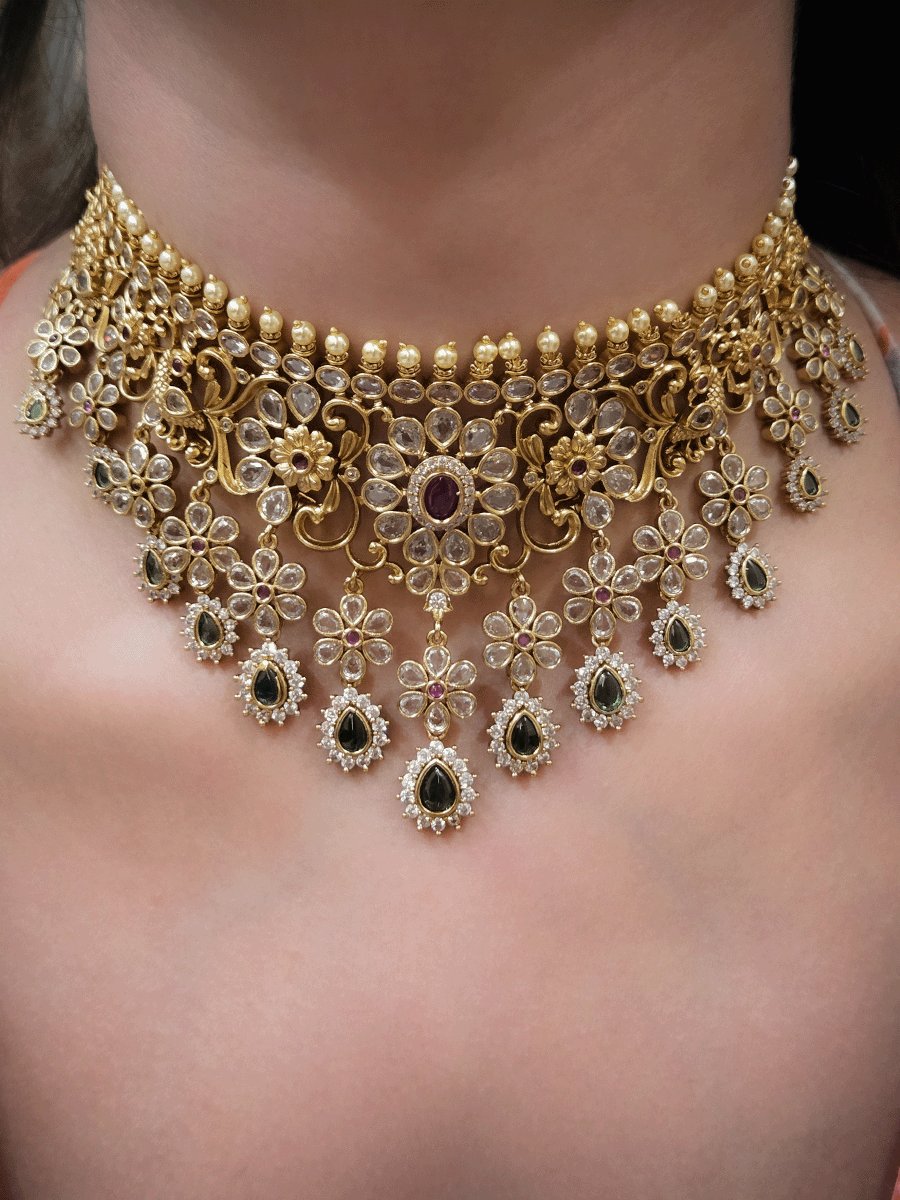 Polki,ruby and green stones studded flower and leaf tukdi tassel drops choker set