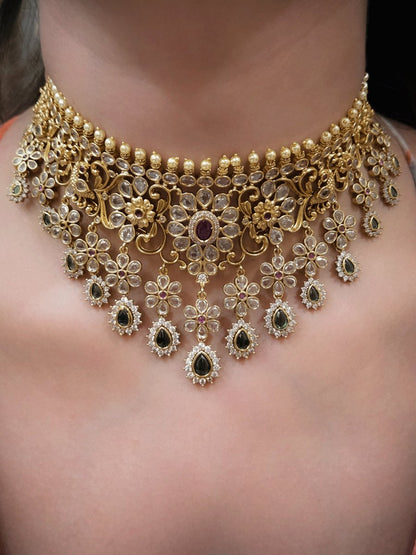Polki,ruby and green stones studded flower and leaf tukdi tassel drops choker set