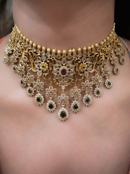 Polki,ruby and green stones studded flower and leaf tukdi tassel drops choker set