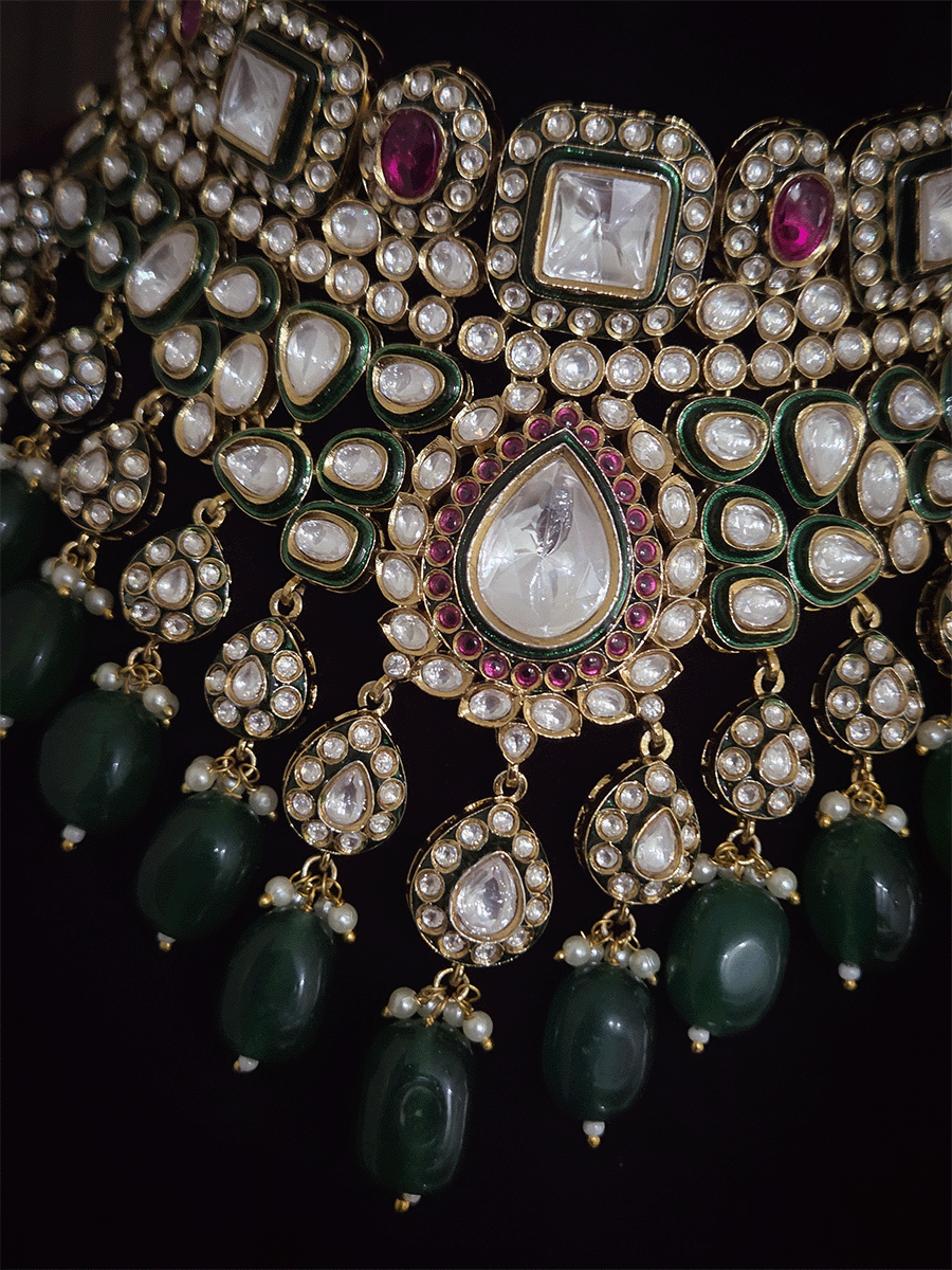 Tear drop and square shaped uncut polki 11cm broad set with green drops and ruby stones detailing