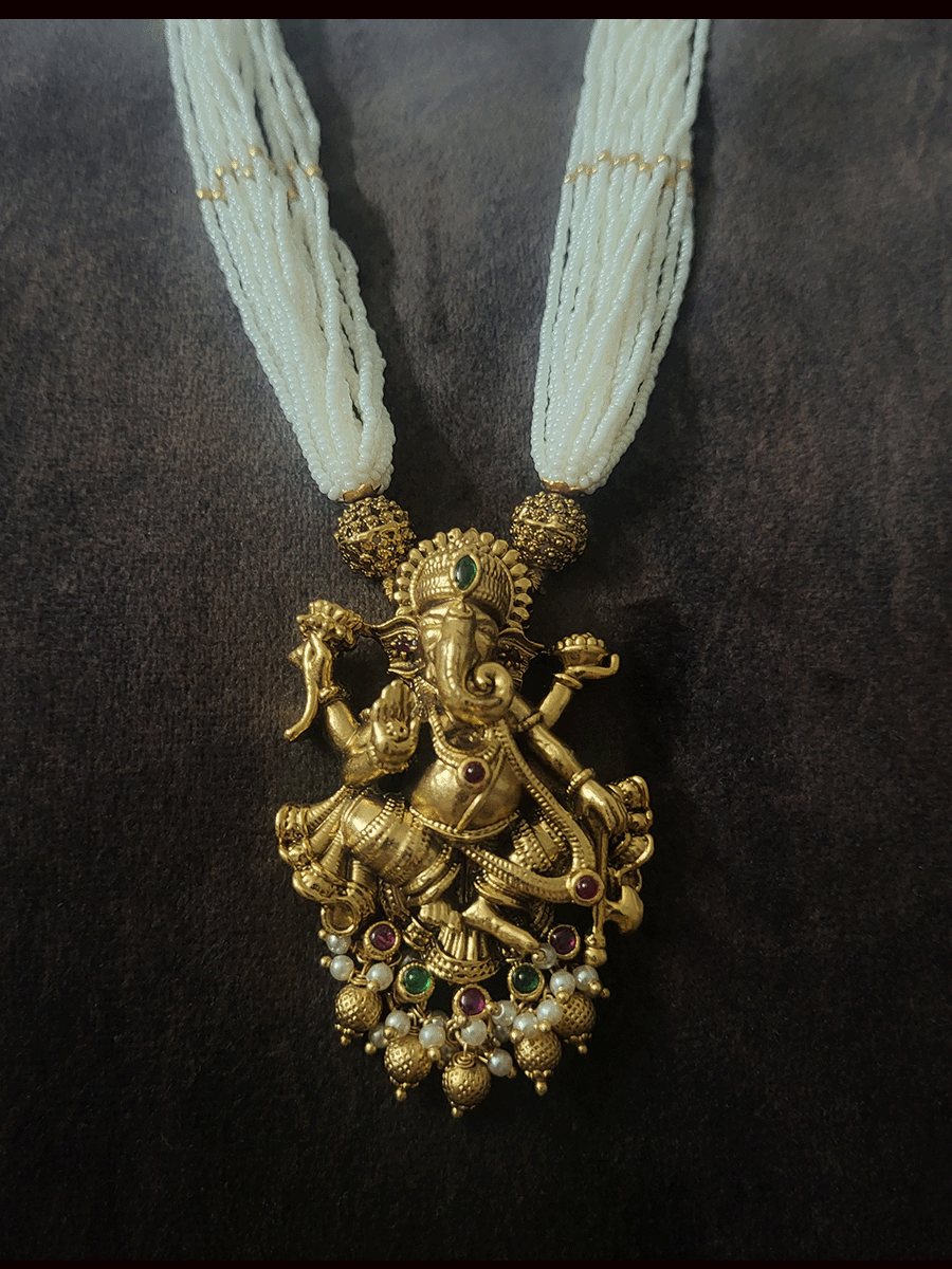 Multiple white cheed strings ganpatiji pendant set embedded with ruby and green stones with ganpatiji top jhoomki