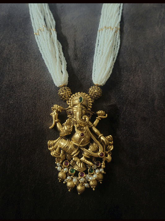 Multiple white cheed strings ganpatiji pendant set embedded with ruby and green stones with ganpatiji top jhoomki